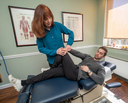Alexandria Chiropractor Dr. Catherine Leavitt working on patient leg