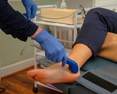 Alexandria Chiropractor Dr. Zhanna doing soft tissue therapy on foot
