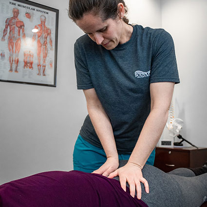 Dr Amanda adjusting a patients lower back