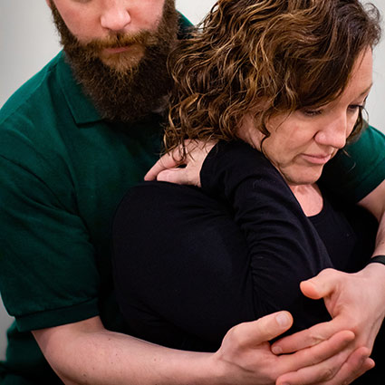 woman doing rehabilitative stretches on arm