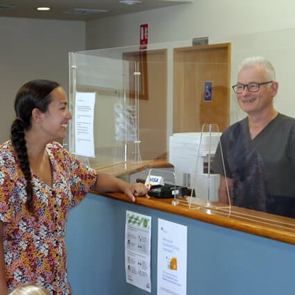 talking with patient at front desk