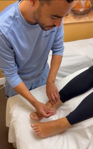 Dr. Jordan Maxwell DC and DACM performing acupuncture on patient's feet at Breathe Chiropractic in Phoenix Arizona