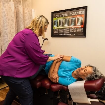Dr Carla adjusting patients back