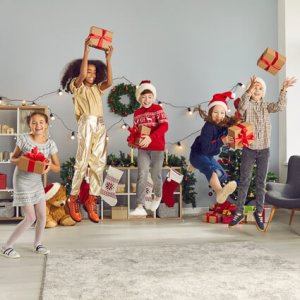 kids jumping holding presents