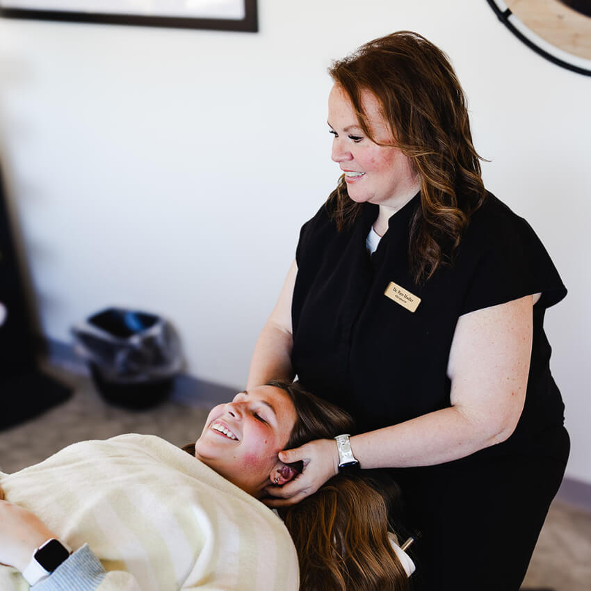 Dr Pam adjusting patients neck