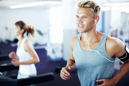 man and woman on treadmills