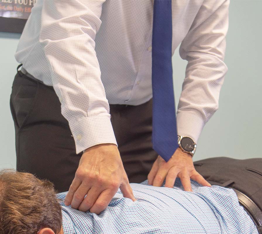 Dr. Luigi adjusting man's back