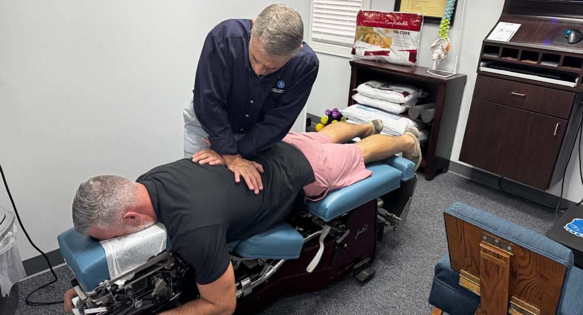 Cheshire chiropractor adjusting patient's back