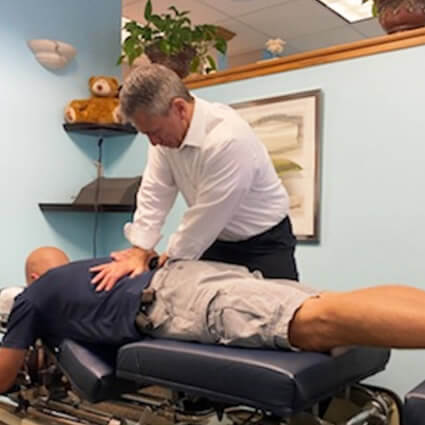 Doctor adjusting mans back