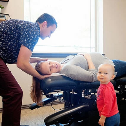 Dr. Harrison adjusting pregnant womans neck