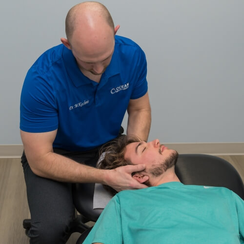 Leland chiropractor adjusting a patient's neck
