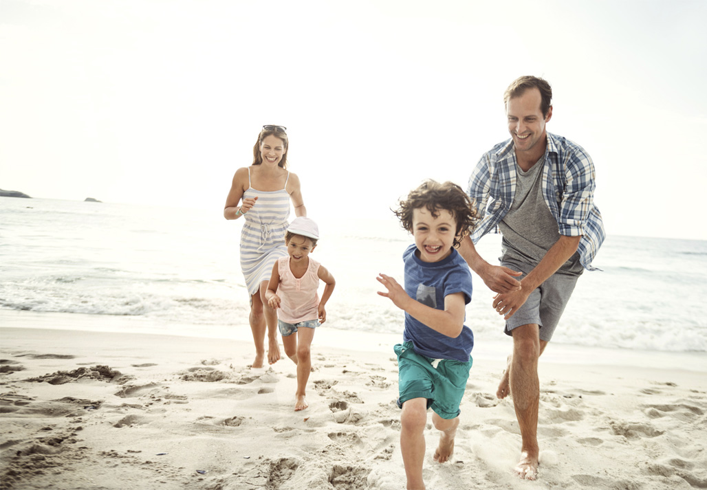 family running on beach