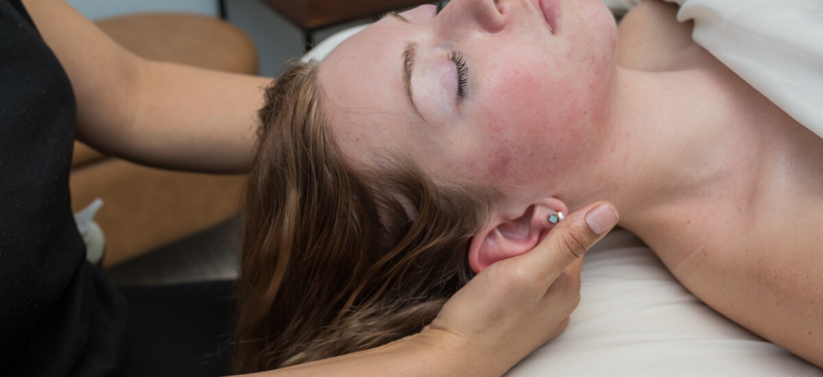 Massage therapist treating a patient's neck