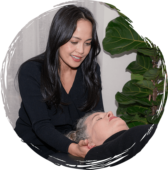 Dr David McRae adjusting patient's neck