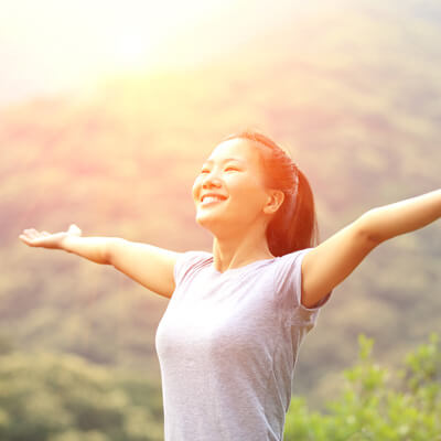 smiling woman with arms outstretched 