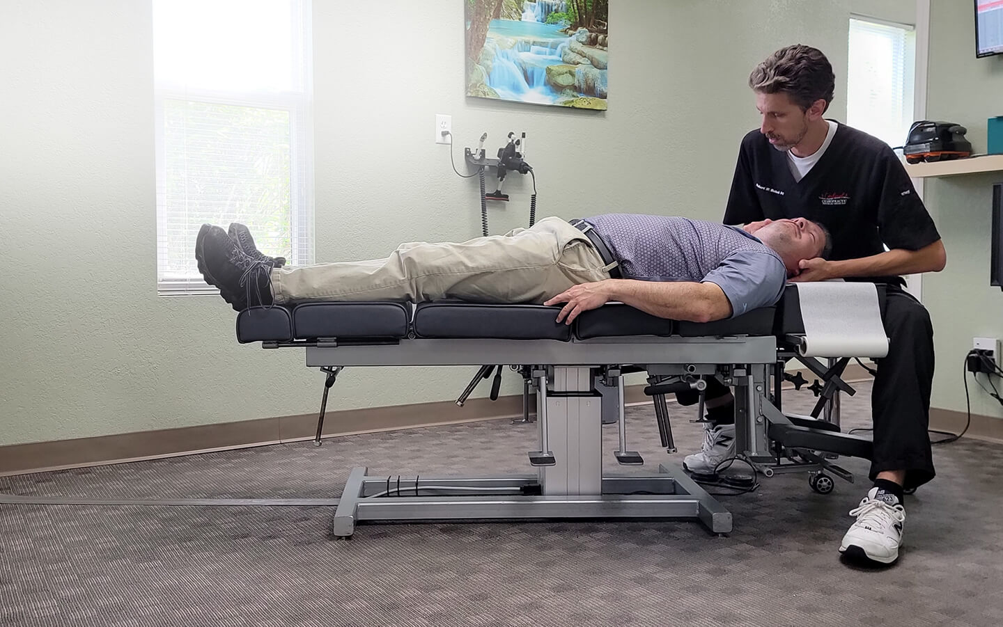 Dr. Blalock adjusting a patient's neck