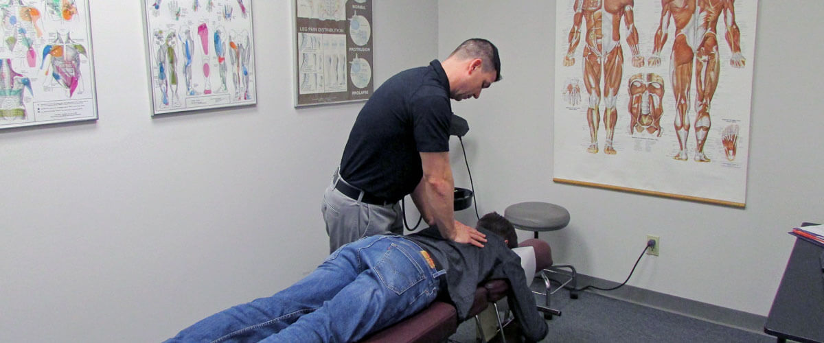 Thoracic adjustment on patient