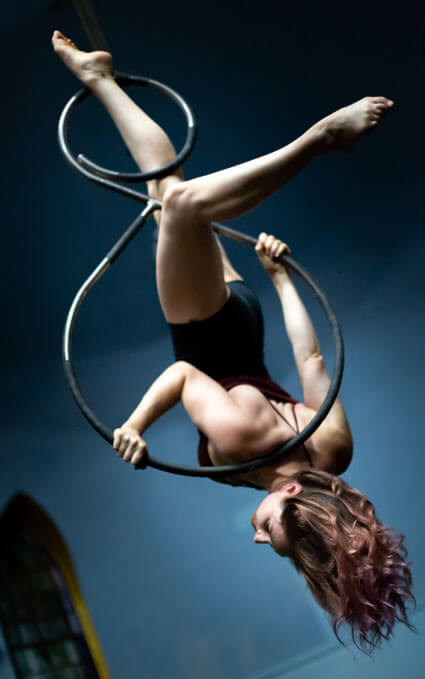 Woman upside down in hula hoops