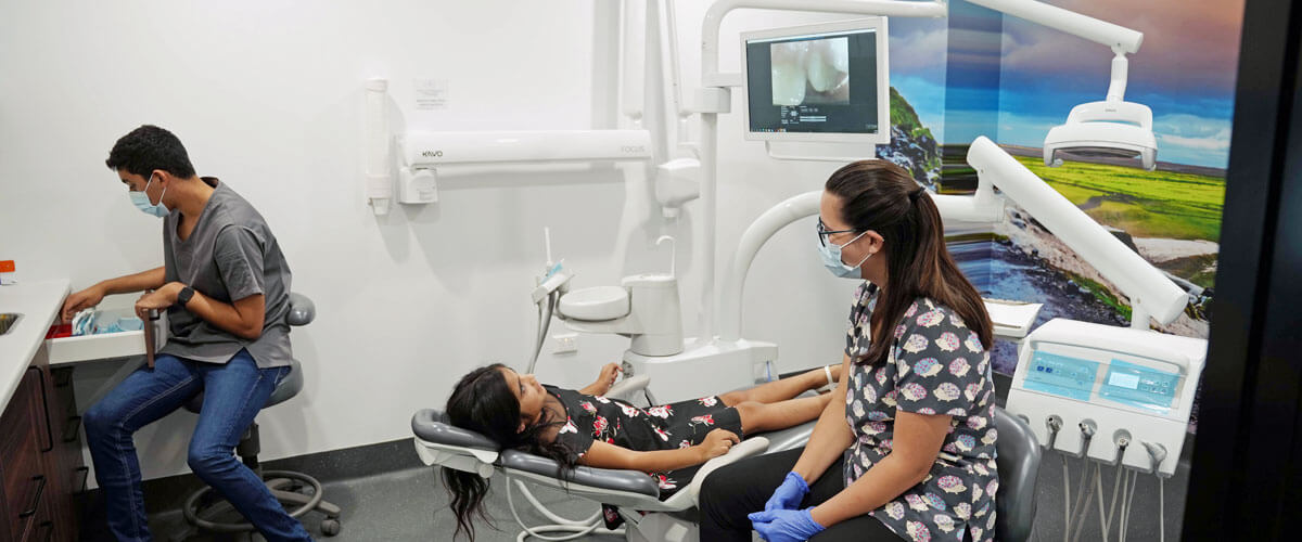 girl in chair with hygienist
