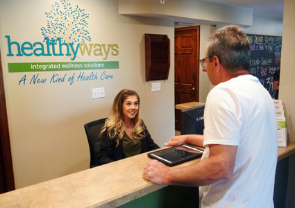 man greeted at front desk