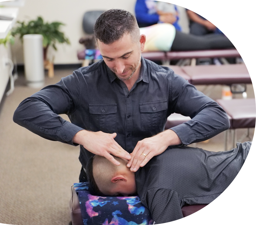 doctor adjusting patients neck