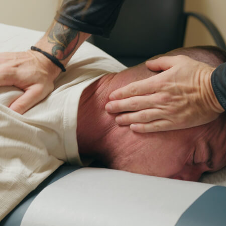 Denver chiropractor adjusting a patient's neck