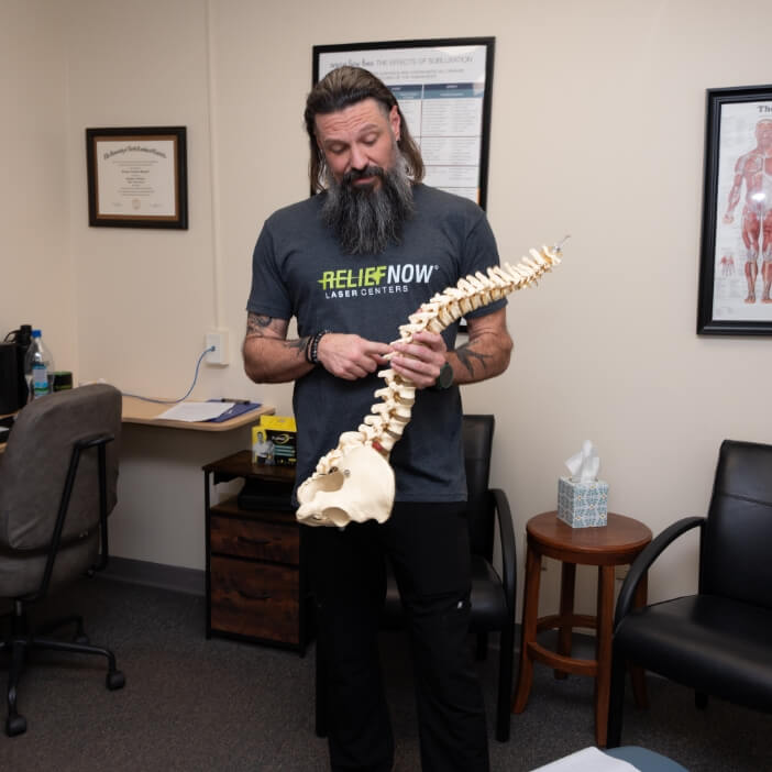 Dr. Coleman holding spine model