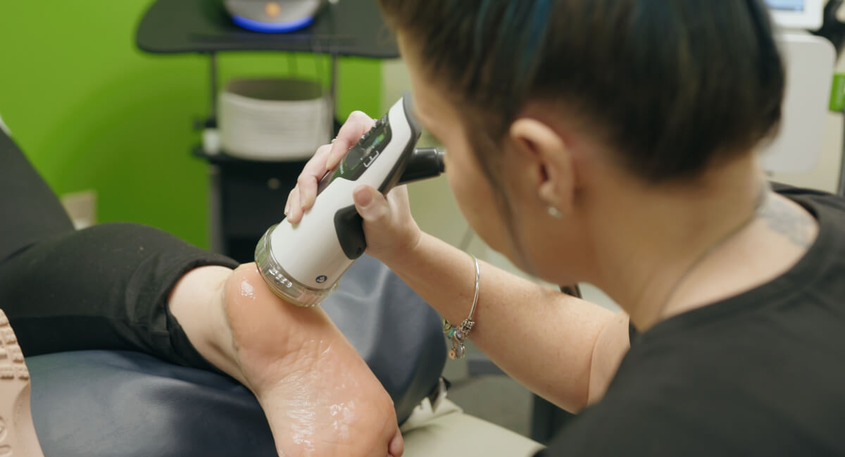 Denver chiropractor treating a patient with Acoustic Shockwave Therapy