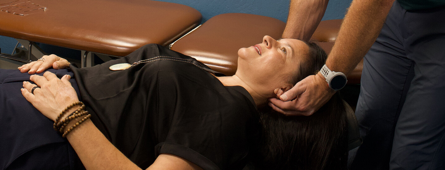 Dr. Callaway gently examining a relaxed patient's neck
