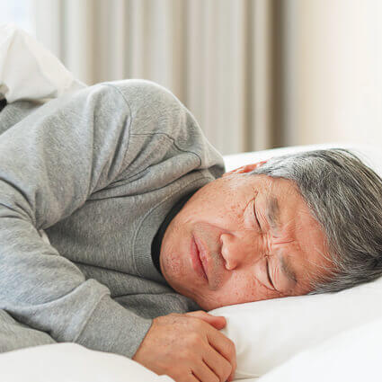 grimacing in pain while asleep