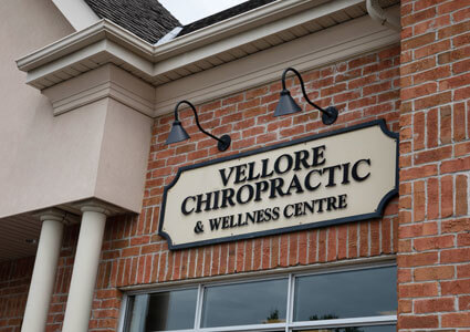 Vellore Chiropractic & Wellness Centre sign on brick wall