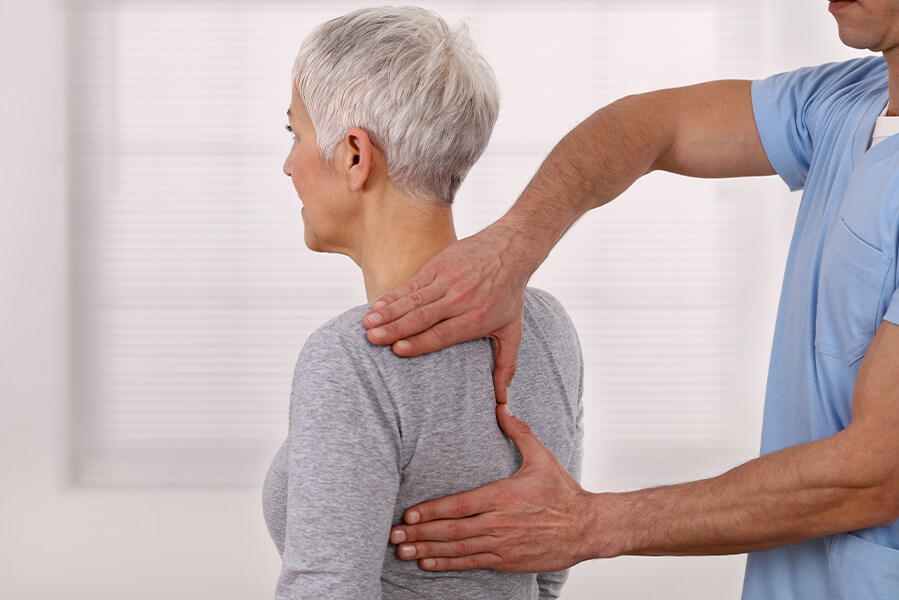 mans hands on patients back