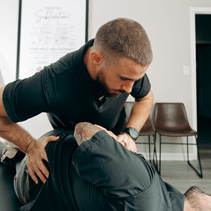 Woodstock Chiropractor Dr. Caleb adjusting patient