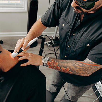 Dr. Austin performing laser therapy