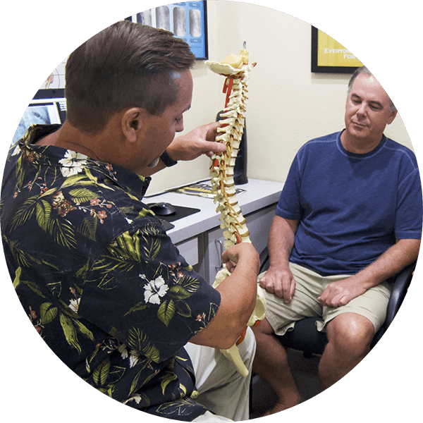 Chiropractor talking with patient