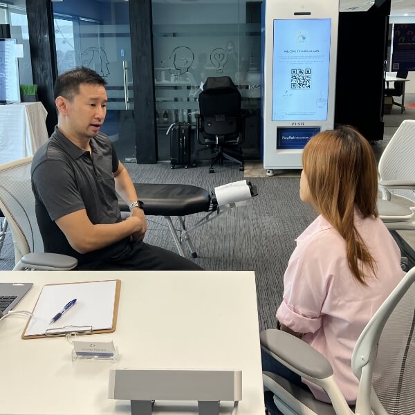 Chiropractor talking to patient