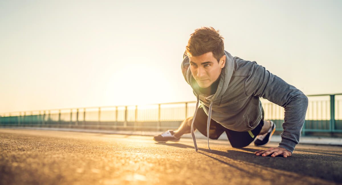 Male athlete doing pushups outdoors