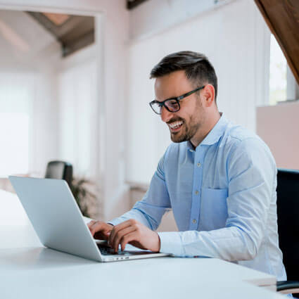 man sitting at table with computer