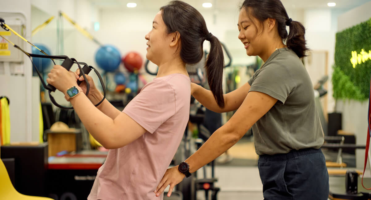 Staff assisting patient with rehabilitative stretches