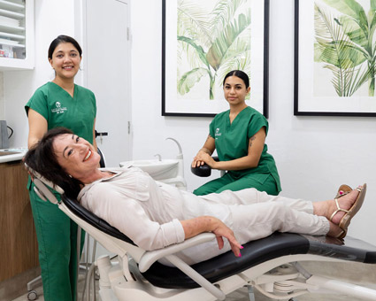 smiling-female-patient-on-dental-chair