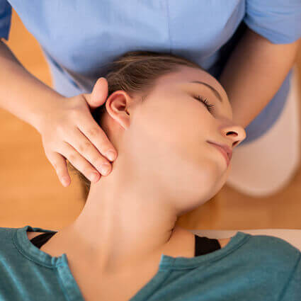 woman-in-teal-shirt-having-neck-adjusted-sq