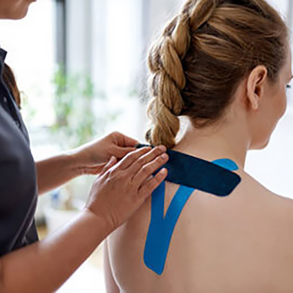 person getting kinesio tape on shoulders