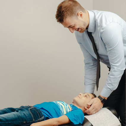 Dr. Nick adjusting young patient