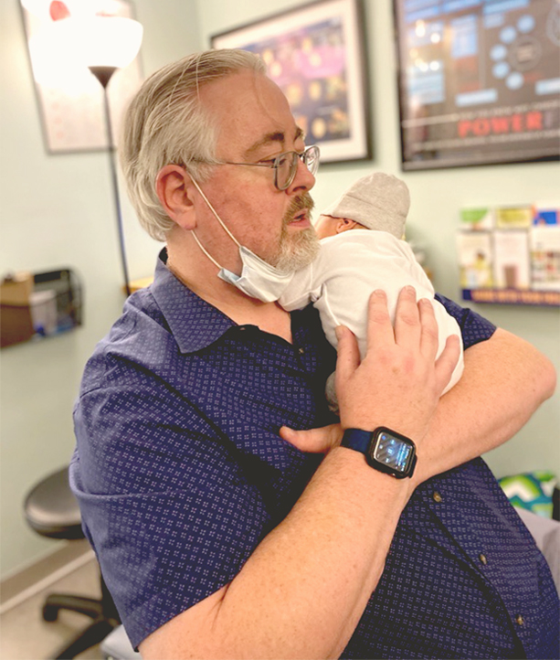 Dr.  McAtamney holding baby