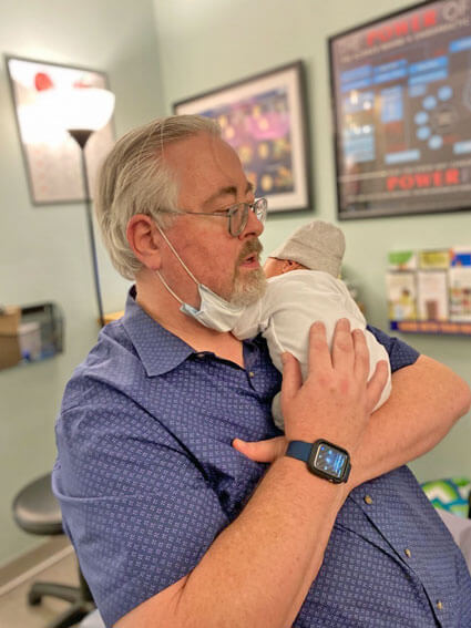 Dr. Mac holding newborn