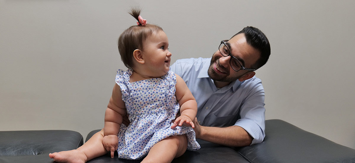 Dr joe smiling at a baby