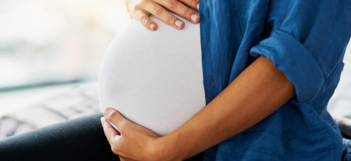 mom holding pregnant tummy