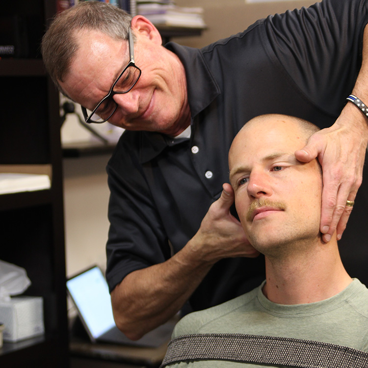 Dr. Phil adjusting mans neck