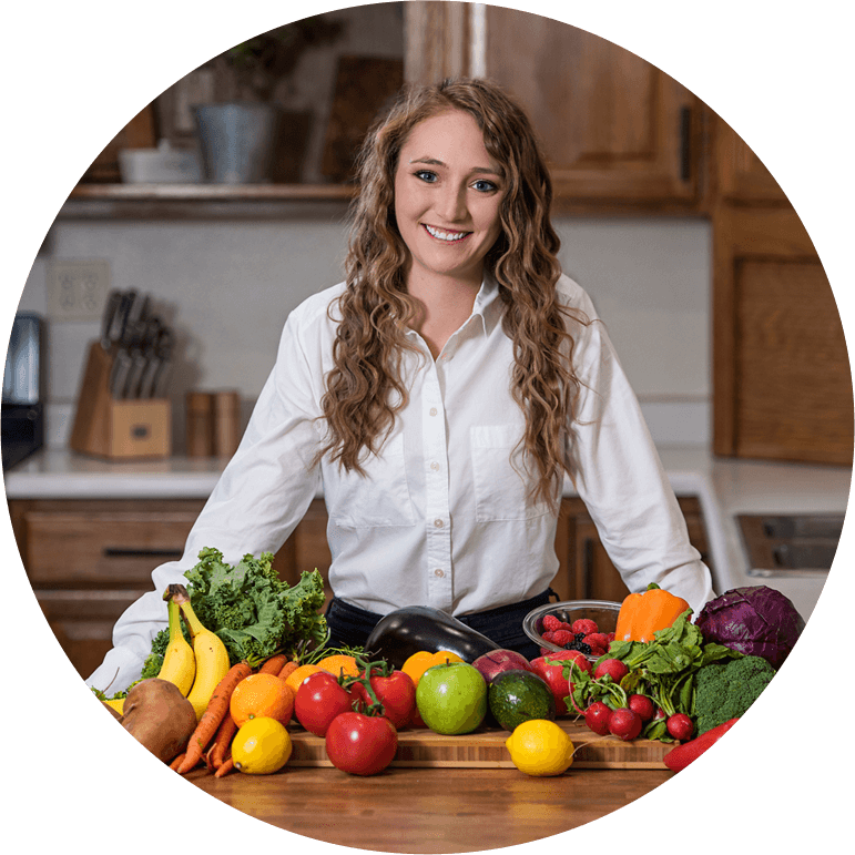 woman standing in front of table of produce