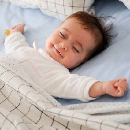 baby girl sleeping in bed